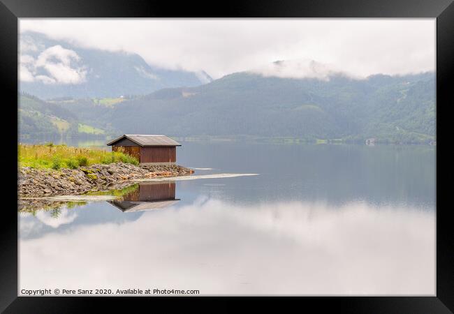 Wooden cabin in the shore of a fjord in Vorway Framed Print by Pere Sanz
