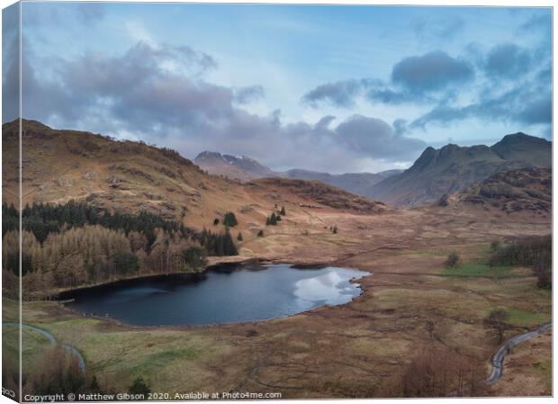 Beautiufl unique drone aerial sunrise landscape image of Blea Tarn and Langdales Range in UK Lake District Canvas Print by Matthew Gibson