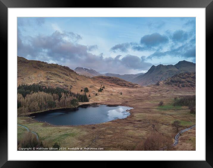 Beautiufl unique drone aerial sunrise landscape image of Blea Tarn and Langdales Range in UK Lake District Framed Mounted Print by Matthew Gibson