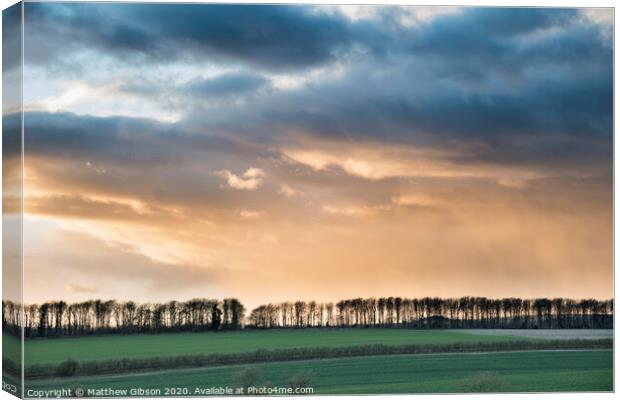 Beautiful stormy moody cloudy sky over English countryside landscape at dusk Canvas Print by Matthew Gibson