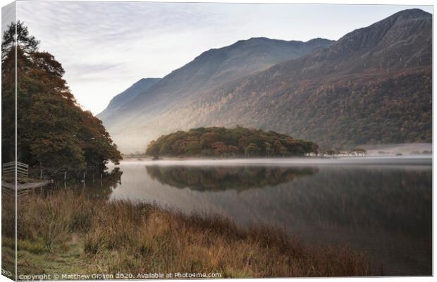 Beautiful Autumn Fall landscape image of Crummock Water at sunrise in Lake District England Canvas Print by Matthew Gibson