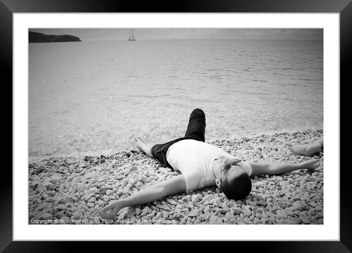A person lying on a beach Framed Mounted Print by M. J. Photography