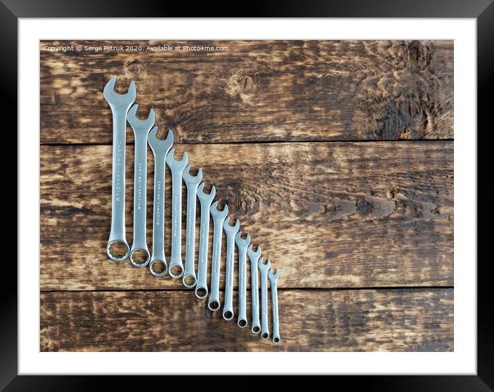 set of wrench against old wooden boards background Framed Mounted Print by Sergii Petruk
