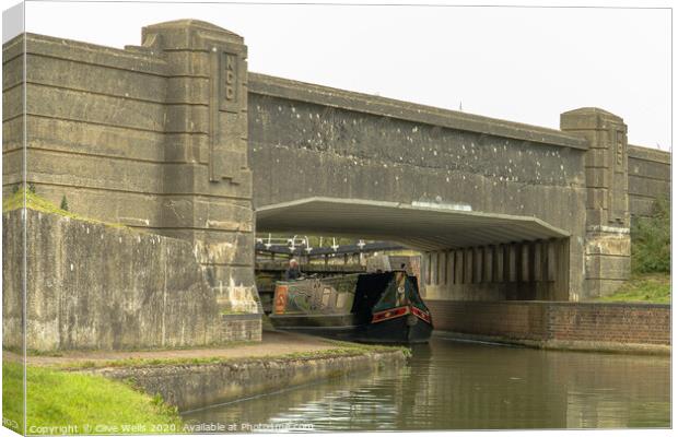 Canal boat under the bridge Canvas Print by Clive Wells