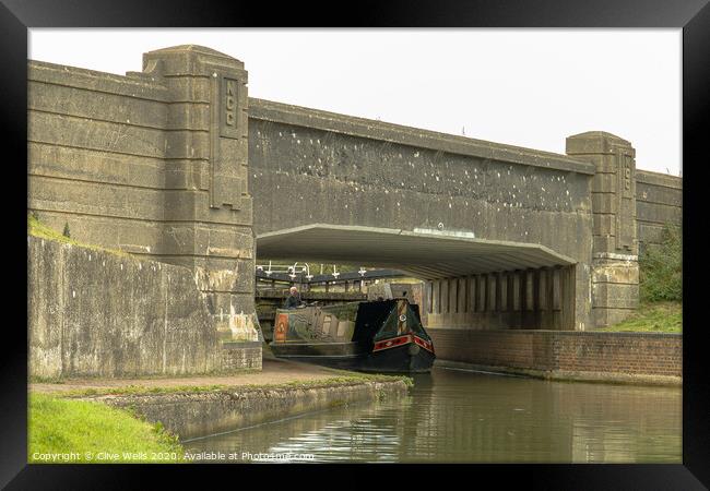 Canal boat under the bridge Framed Print by Clive Wells
