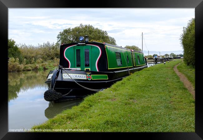 Narrow boat moored up in front of lock gates. Framed Print by Clive Wells