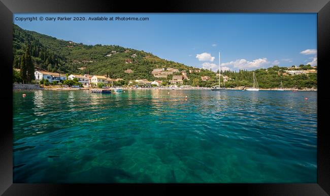 The clear waters of Kalami Bay, in Corfu, Greece, on a bright summers day	 Framed Print by Gary Parker