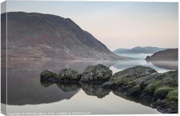 Stunning Winter foggy sunrise on Crummock Water in Lake District England Canvas Print by Matthew Gibson
