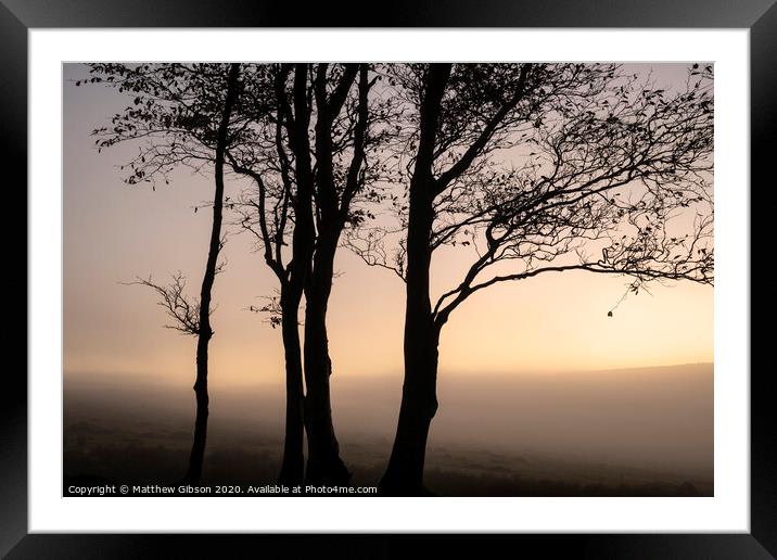 Beautiful foggy sunrise landscape over the tors in Dartmoor revealing peaks through the mist Framed Mounted Print by Matthew Gibson