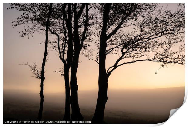 Beautiful foggy sunrise landscape over the tors in Dartmoor revealing peaks through the mist Print by Matthew Gibson
