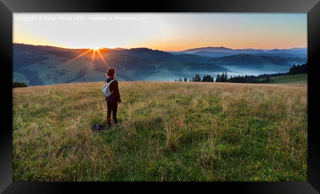 A young woman meets a dawn on a meadow hill in the Carpathian Mountains Framed Print by Sergii Petruk