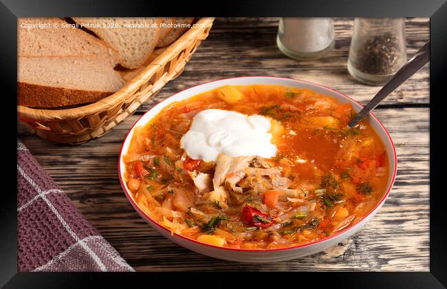 Ukrainian borsch in a white porcelain dish on an old wooden table Framed Print by Sergii Petruk