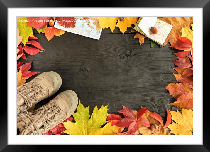 Autumn leaves, tracking boots and maps on a black background of an old tree Framed Mounted Print by Sergii Petruk
