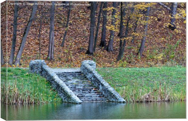old steps of stone descent on the shore of a forest pond. Canvas Print by Sergii Petruk