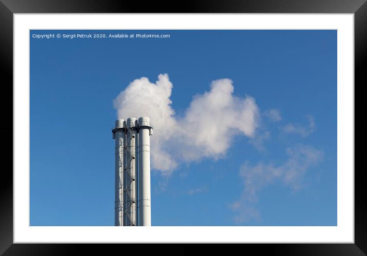 White smoke comes from a white chimney pipe on a background of blue sky. Framed Mounted Print by Sergii Petruk