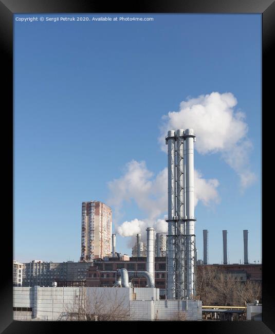 White smoke comes from a white chimney heat station pipe on a blue sky background. Framed Print by Sergii Petruk