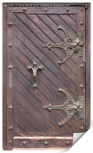 Ancient antique wooden doors with wrought iron loops and cross bars. Print by Sergii Petruk