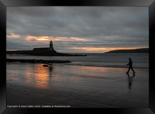 Silhouette of Harbour Light Tower and walker at du Framed Print by Dave Collins