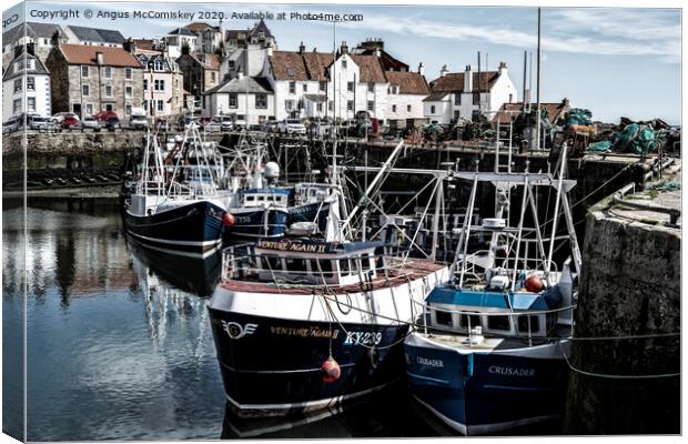 Fishing boats moored in Pittenweem Harbour Canvas Print by Angus McComiskey