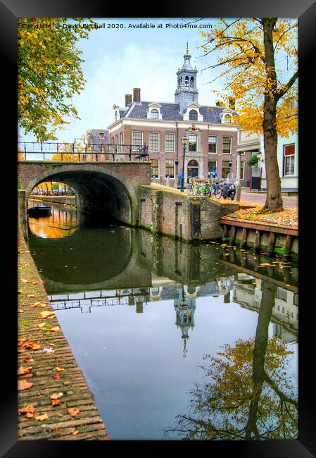 Autumnal canal scene in Edam, Netherlands. Framed Print by David Birchall