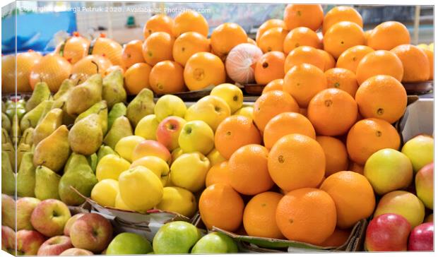 oranges, apples, pears lie on the market counter for sale Canvas Print by Sergii Petruk