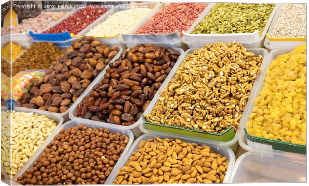 walnut, dates, hazelnuts, almonds, cashews, raisins, peanuts and other cereals for sale on the market Canvas Print by Sergii Petruk