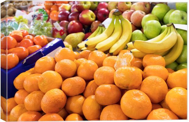 mandarins, bananas, apples lie on the market counter for sale Canvas Print by Sergii Petruk