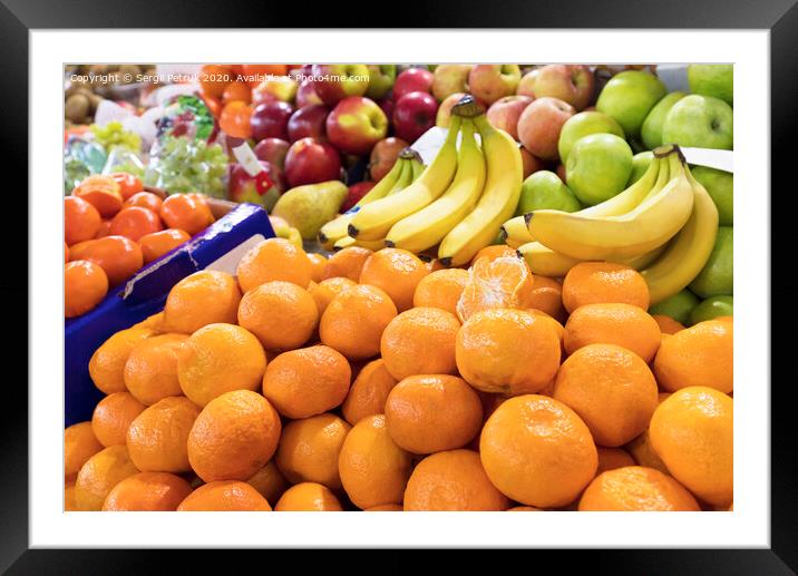 mandarins, bananas, apples lie on the market counter for sale Framed Mounted Print by Sergii Petruk