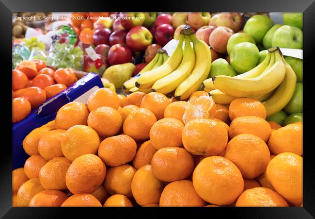 mandarins, bananas, apples lie on the market counter for sale Framed Print by Sergii Petruk