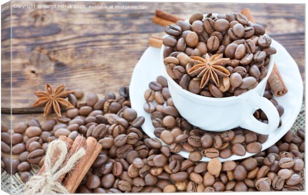 Grain coffee in a cup. Cinnamon on a platter and tied with string. Anise stars complement the aroma of coffee. Canvas Print by Sergii Petruk