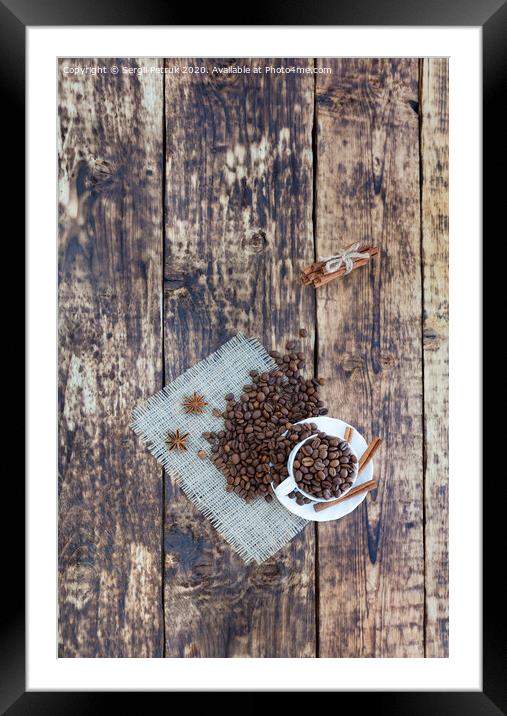 Grain coffee in a cup, which stands on a sackcloth from burlap. Cinnamon on a platter and tied with a rope. Anise stars complement the aroma of coffee. View from above. Framed Mounted Print by Sergii Petruk