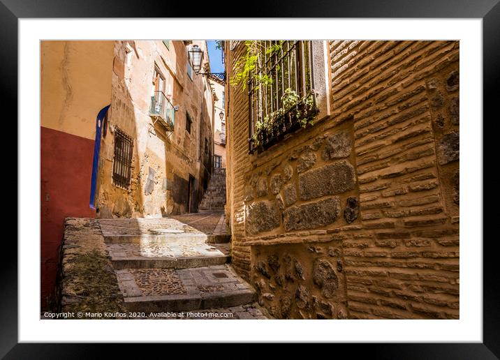 Medieval cobbled and stepped street in the city of Toledo. Spain Framed Mounted Print by Mario Koufios