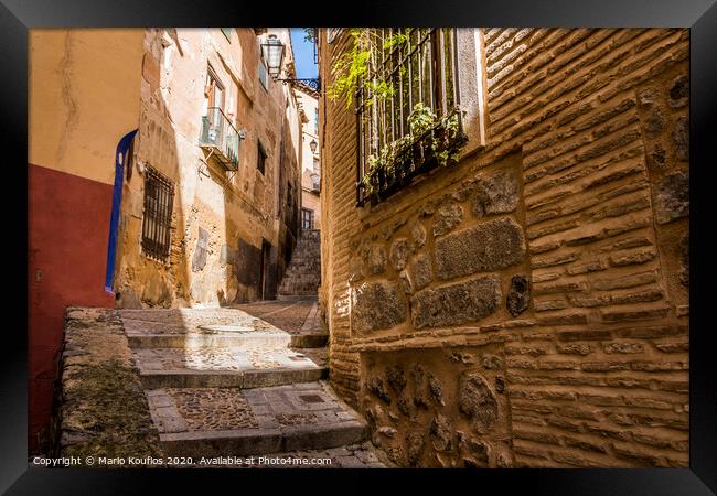 Medieval cobbled and stepped street in the city of Toledo. Spain Framed Print by Mario Koufios