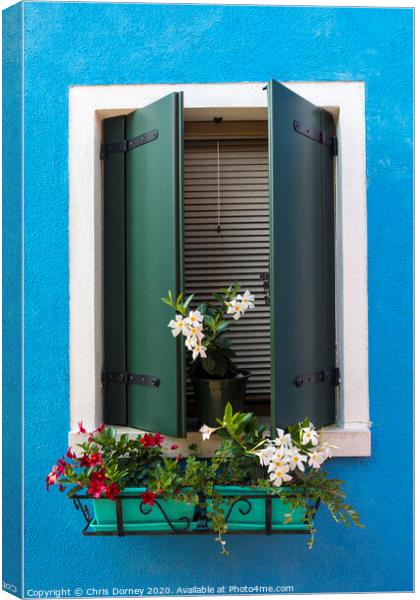 Window with Flowers in Burano Canvas Print by Chris Dorney