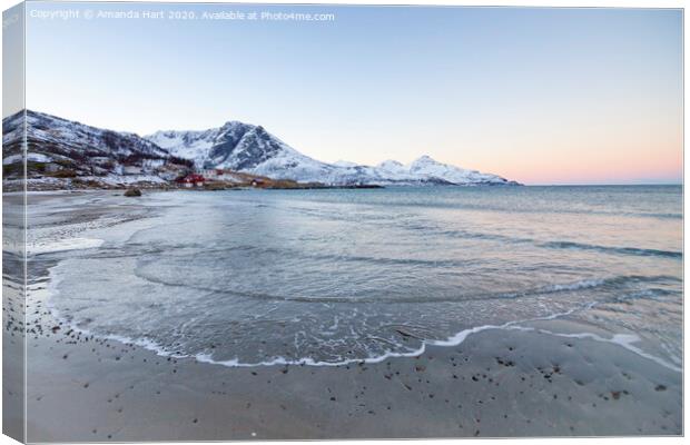 Snowy mountains from a beach in Norway Canvas Print by Amanda Hart