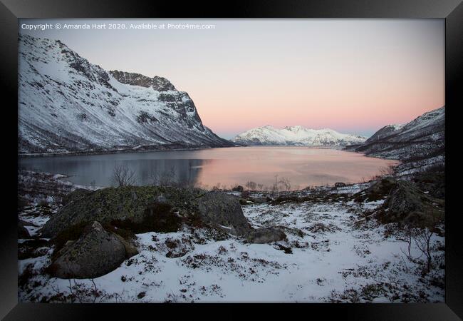 Winter sun over a fjord in Norway Framed Print by Amanda Hart