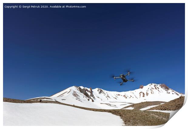 A flying toy hovered over the top of Mount Ercius against the blue sky. Print by Sergii Petruk