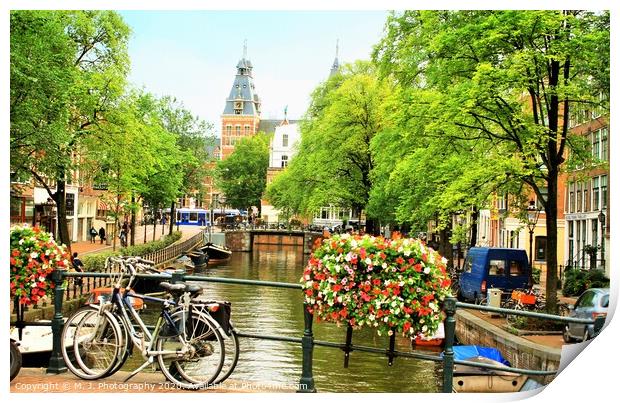 A bicycle parked on the side of a river in Amsterd Print by M. J. Photography