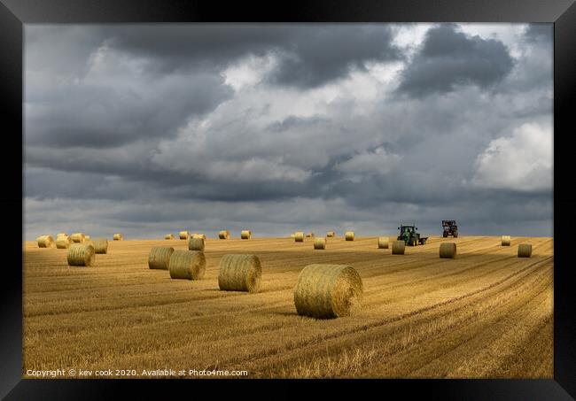 Bales and tractors Framed Print by kevin cook