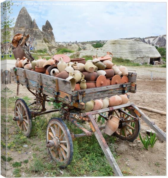 On an old wooden cart, a pile of clay jugs and pots Canvas Print by Sergii Petruk