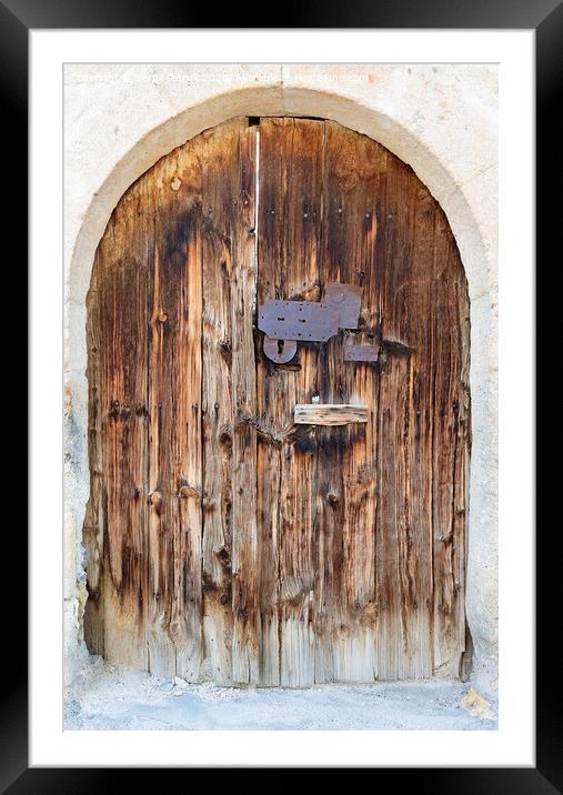 Ancient arched antique wooden doors with a metal lock in the middle Framed Mounted Print by Sergii Petruk