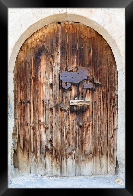 Ancient arched antique wooden doors with a metal lock in the middle Framed Print by Sergii Petruk