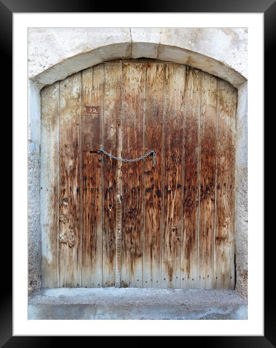 Ancient trapezoidal antique wooden doors with a metal lock in the middle Framed Mounted Print by Sergii Petruk