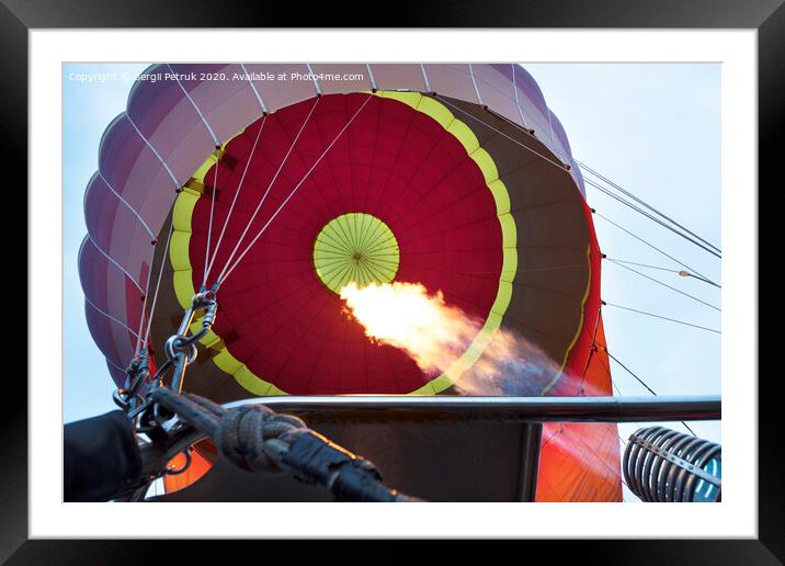 The flame of a gas burner inflates a balloon Framed Mounted Print by Sergii Petruk
