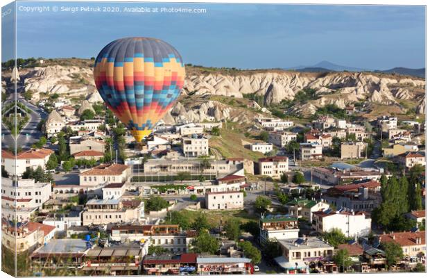 A balloon is flying over the valley in Cappadocia Canvas Print by Sergii Petruk
