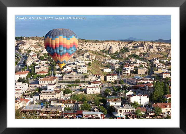 A balloon is flying over the valley in Cappadocia Framed Mounted Print by Sergii Petruk