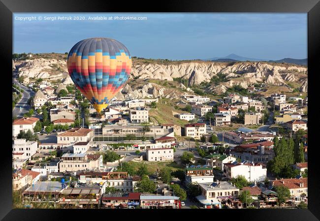 A balloon is flying over the valley in Cappadocia Framed Print by Sergii Petruk