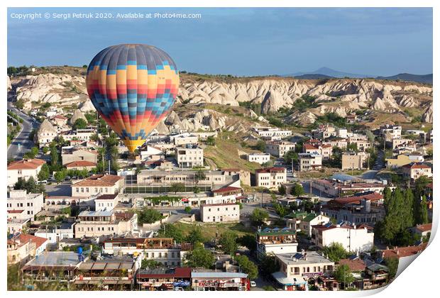 A balloon is flying over the valley in Cappadocia Print by Sergii Petruk