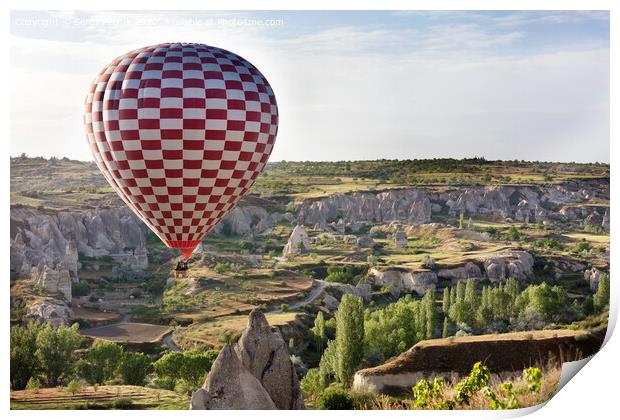 A balloon is flying over the valley in Cappadocia Print by Sergii Petruk
