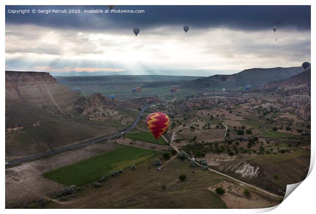 A balloons is flying over the valley in Cappadocia Print by Sergii Petruk